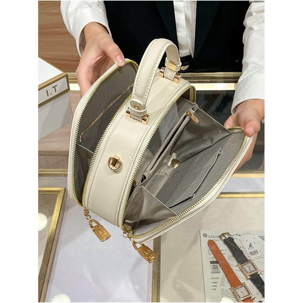 Hong Kong counter genuine leather bag women s 2025 new fashionable simple hand held small round bag high end single shoulder crossbody bag image 4